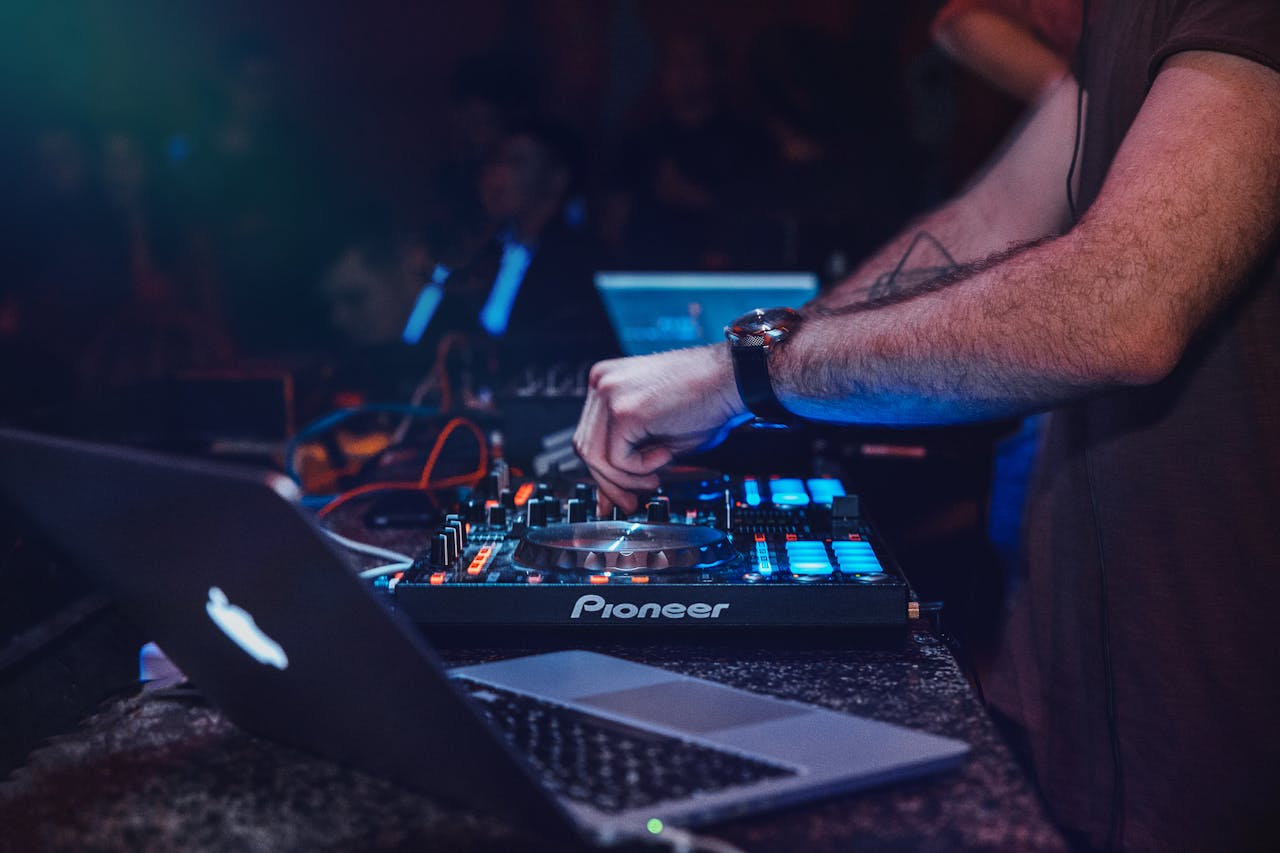 DJ performing with mixer in a vibrant nightclub setting. Perfect for entertainment and technology themes.